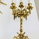 Massive gilded bronze chandeliers from the mid-20th century with marble bases.