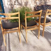 3 Scandinavian style chairs, light wood and black faux leather.
