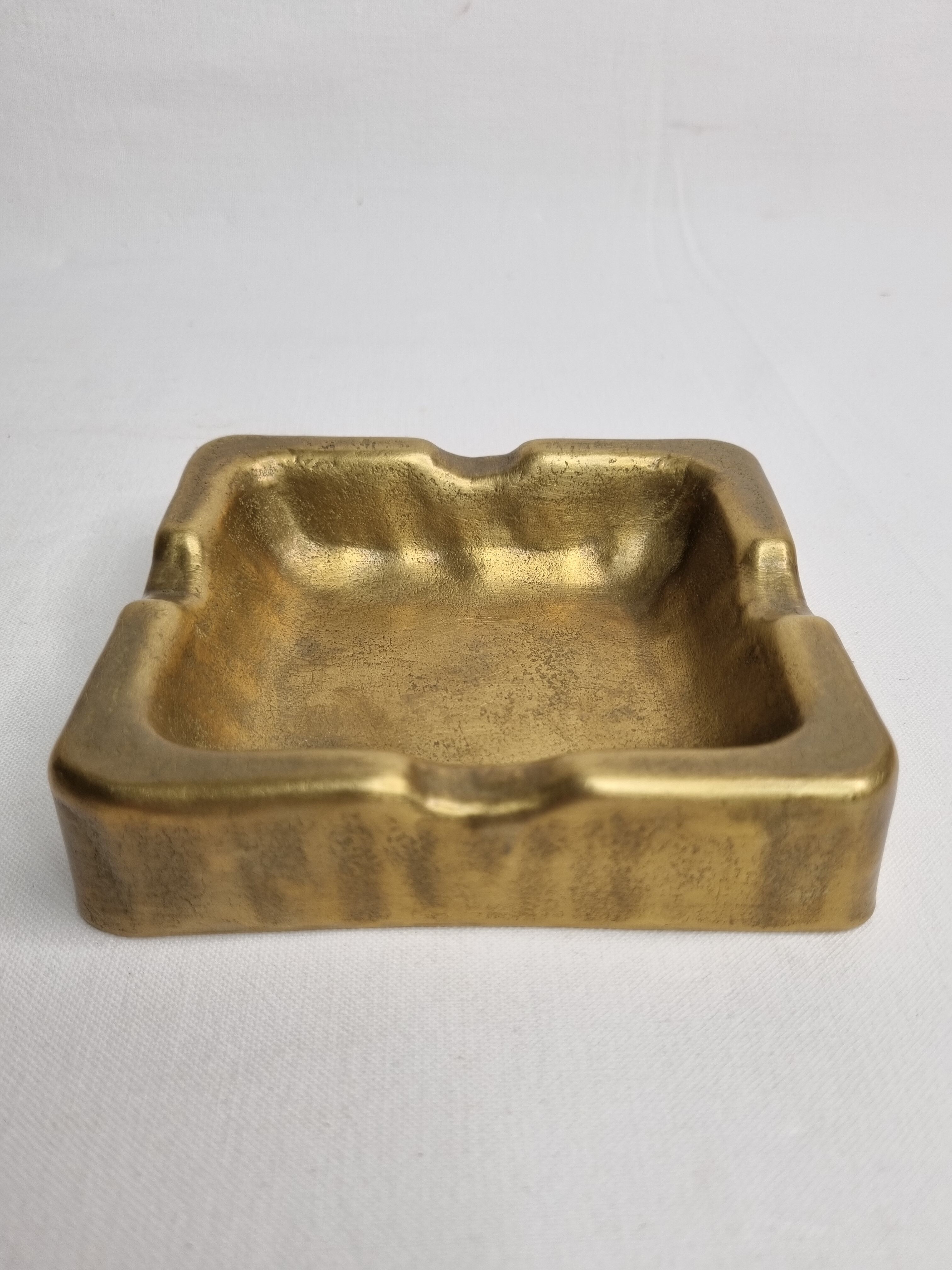 Empty pocket brutalist-inspired ashtray in gilded bronze