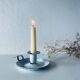 Old candle holder in white enameled metal