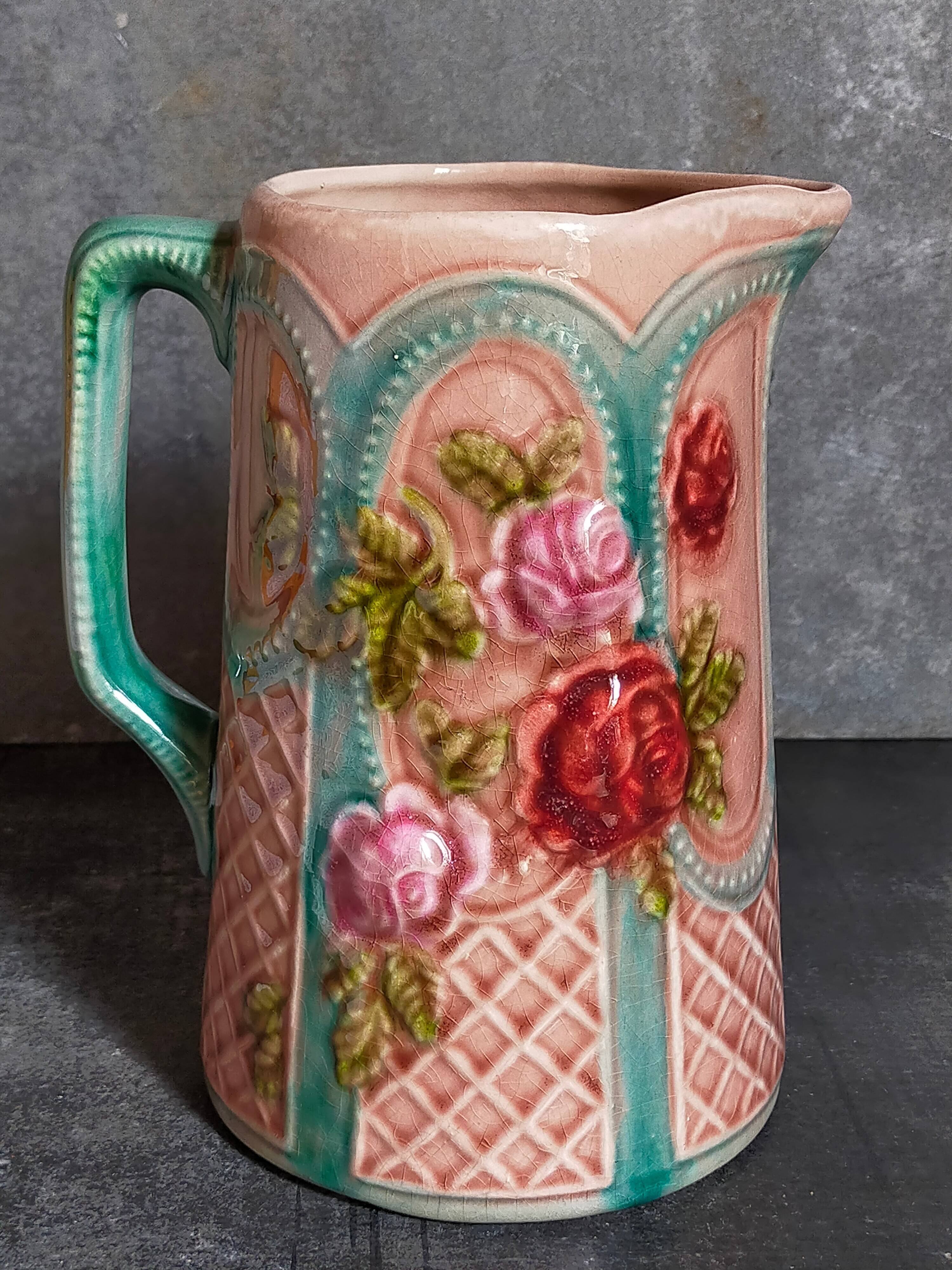 Antique slip pitcher with blooming roses