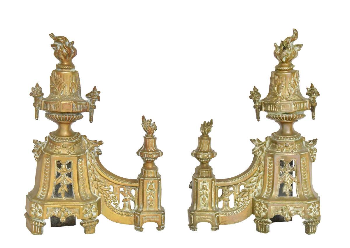 Pair of gilded brass fire dogs decorated with fire pots in the Louis XVI style.