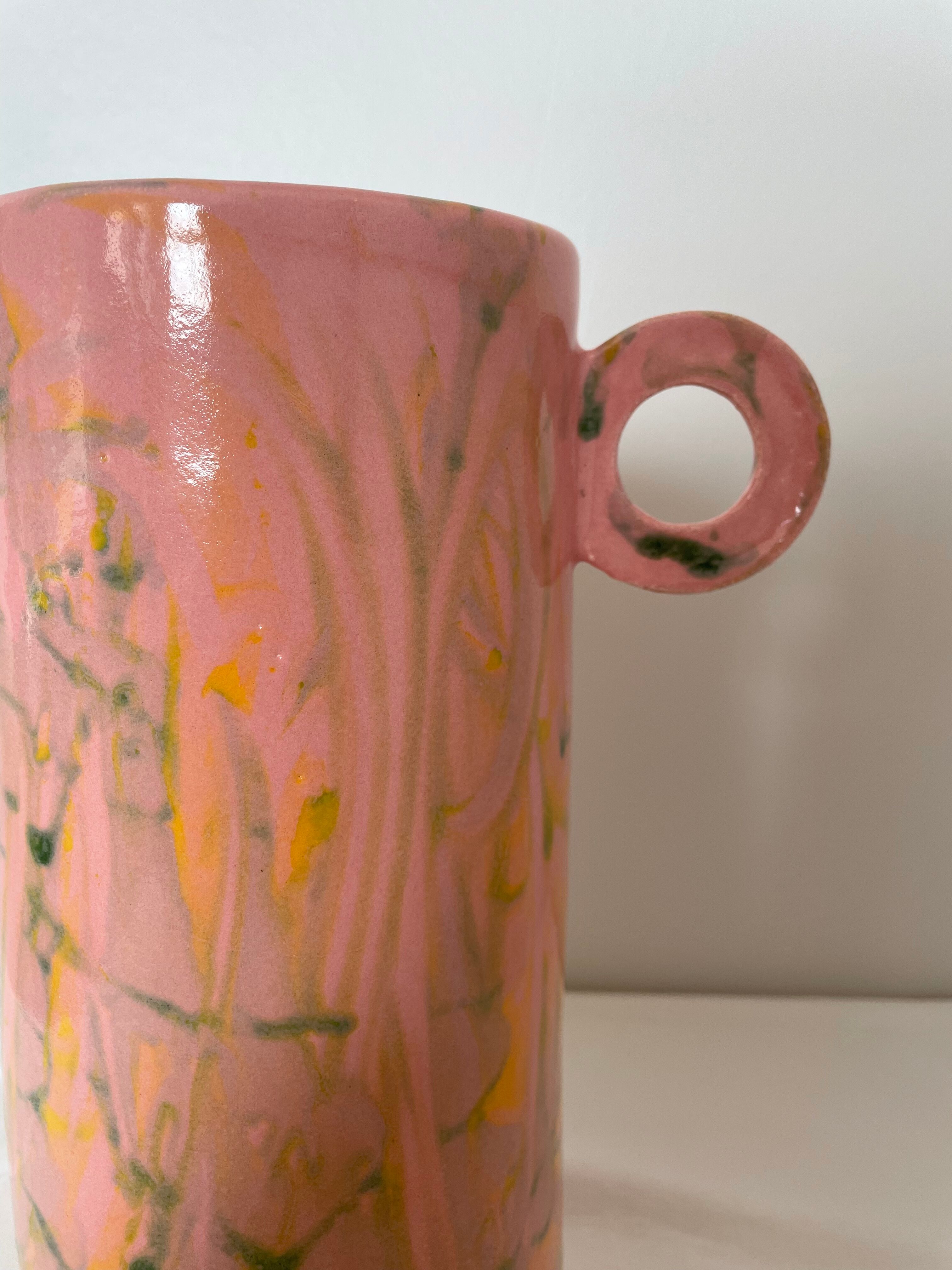 Pink ceramic vase with abstract circular handles
