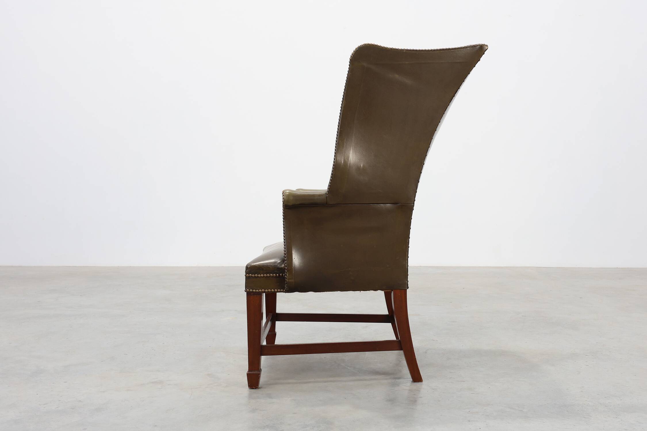 Mid-century Wing Back Armchair in green leather, UK