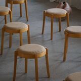 Modern Swedish, set of 14 stackable stools in birch and hessian fabric, 1980s.