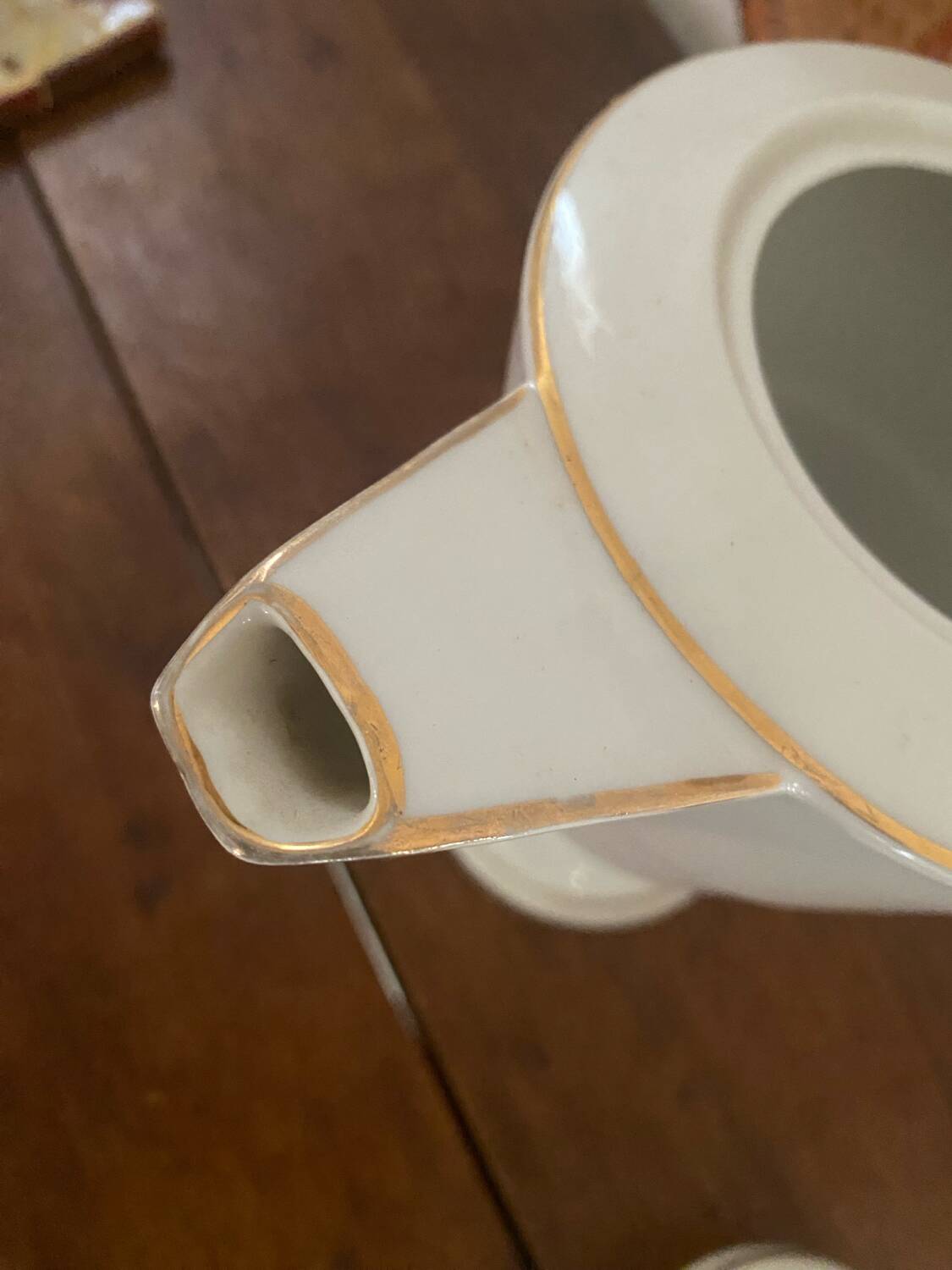 White and gold porcelain coffee pot in art deco style.