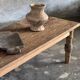 Brown Indonesian teak coffee table, with a border and cylindrical legs H40 L103.