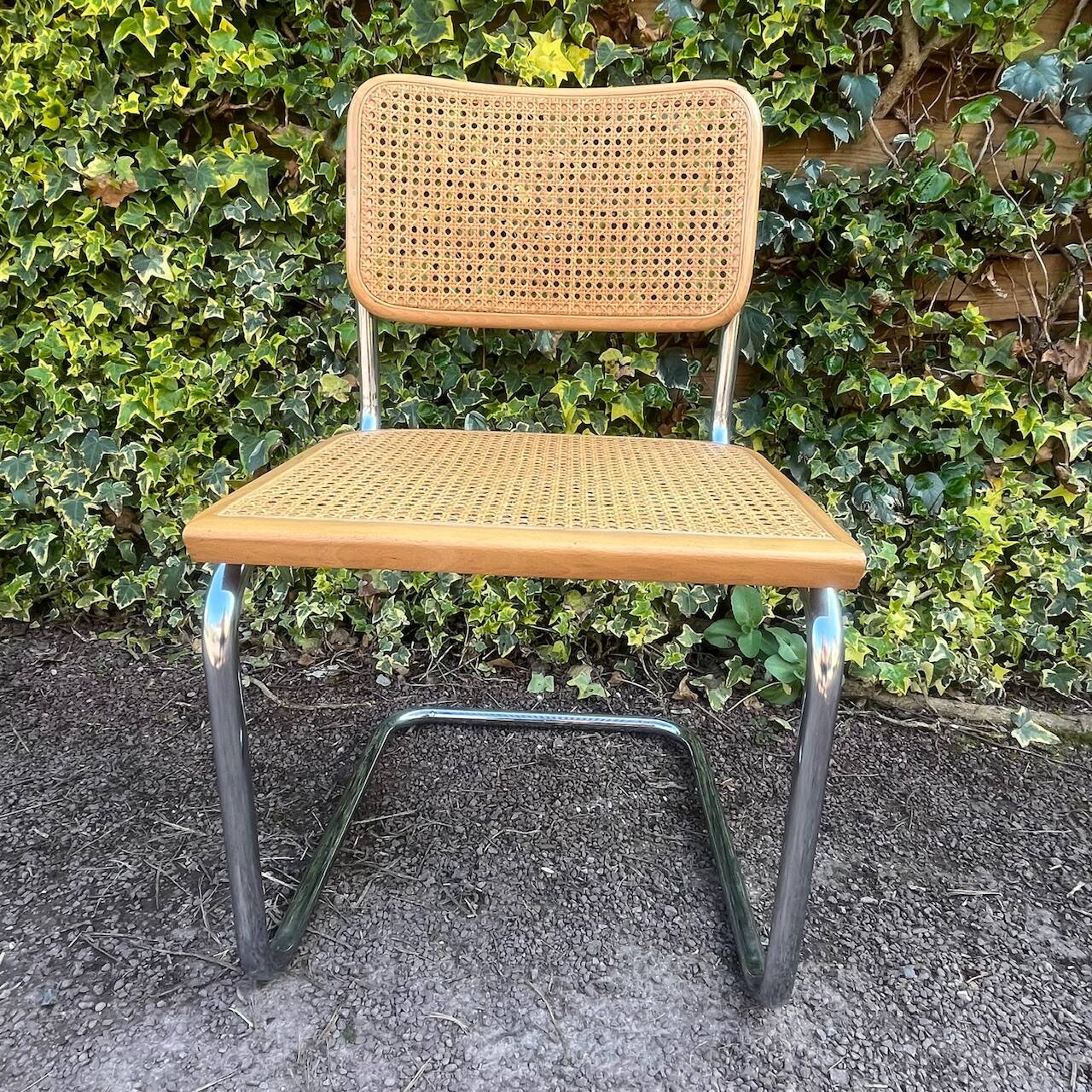 Wooden chair with caning in the style of Marcel Breuer.