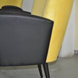 Pair of vintage 1950s cocktail chairs in yellow velvet and black faux leather, wooden frame.