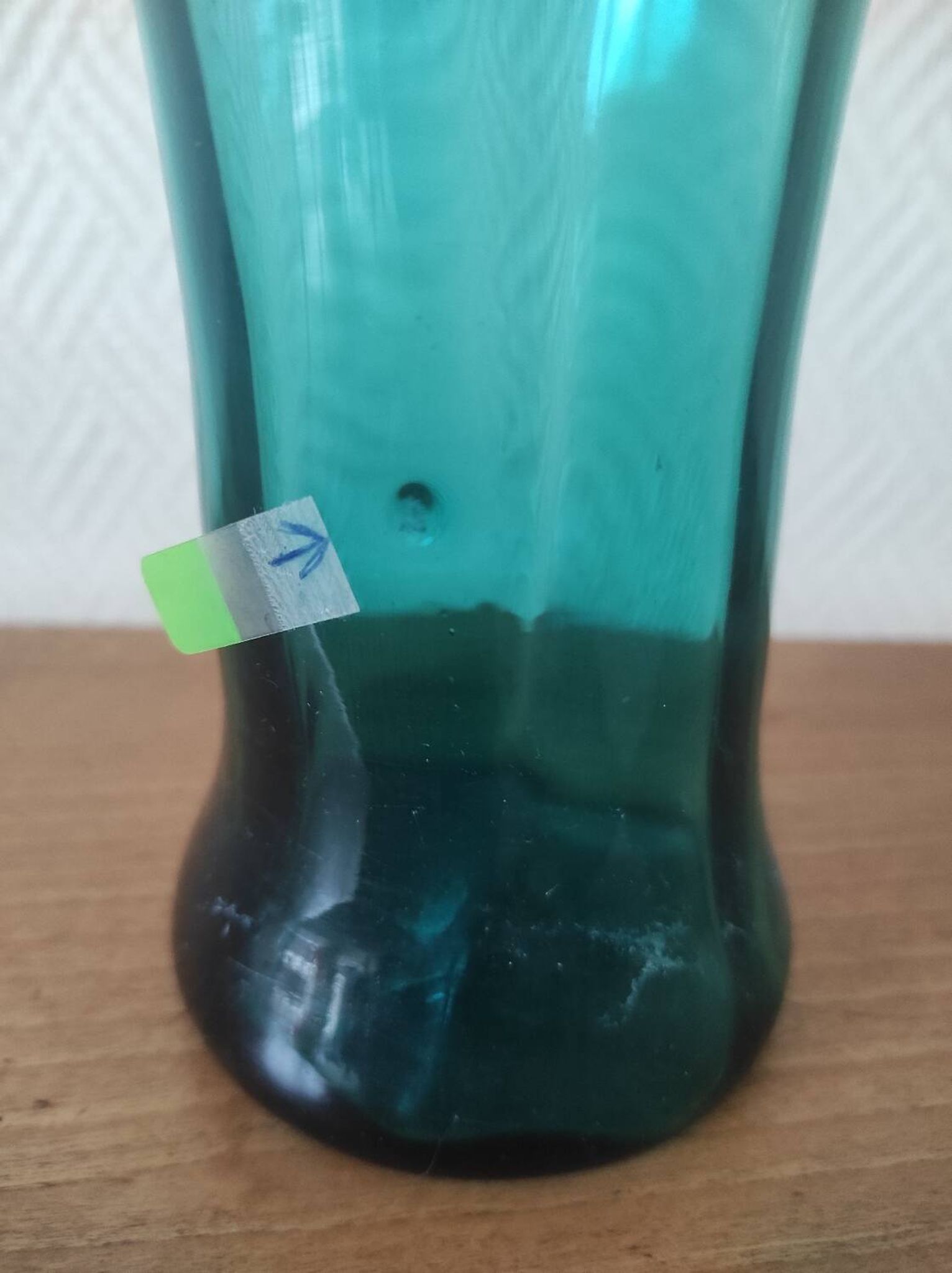 Blown glass vase with a flared neck and wavy rim.