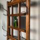 Art Deco wall-mounted coat rack in oak, early 20th century. Beveled central mirror