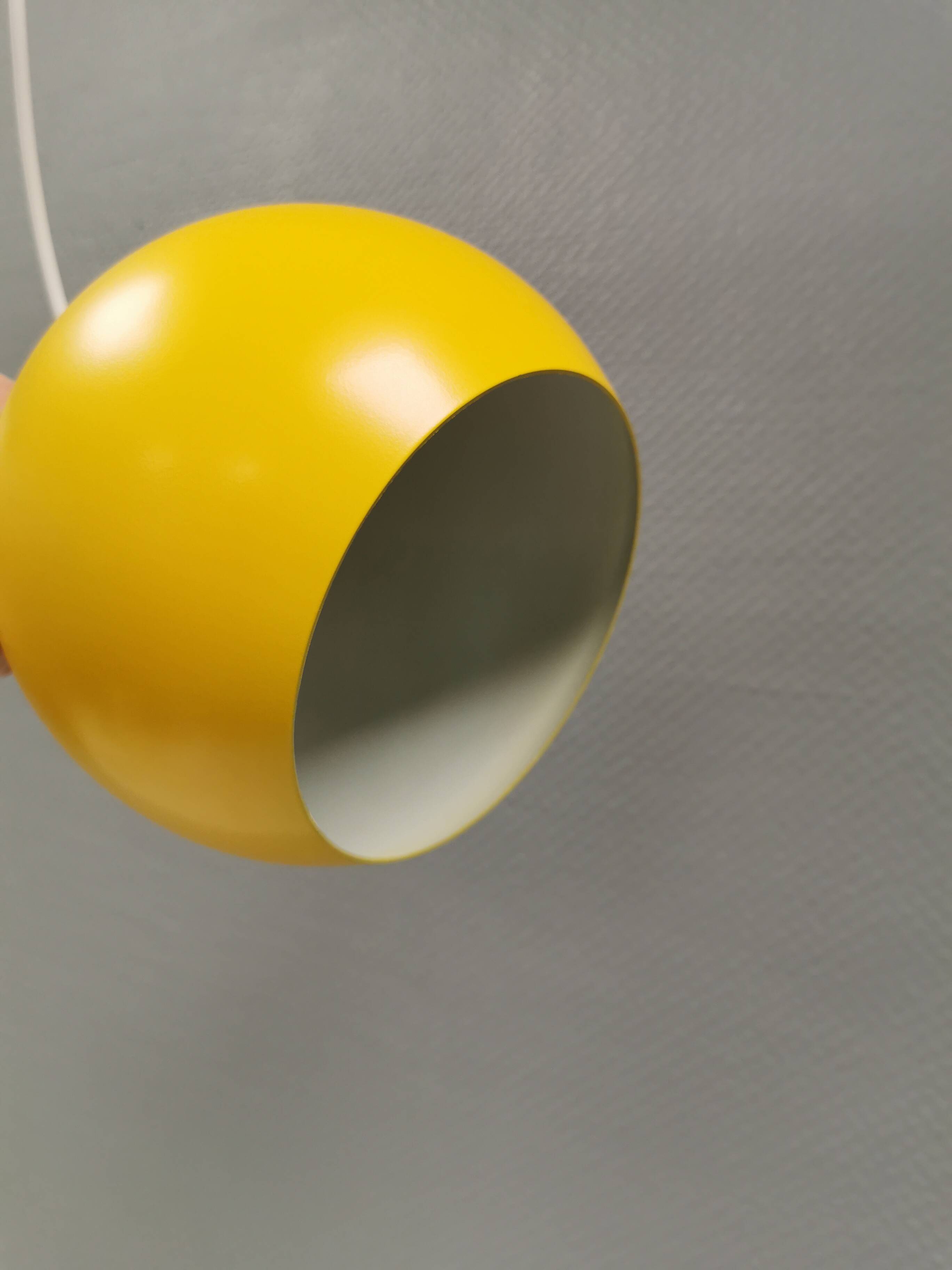Spherical pendant lamp in sunny yellow.