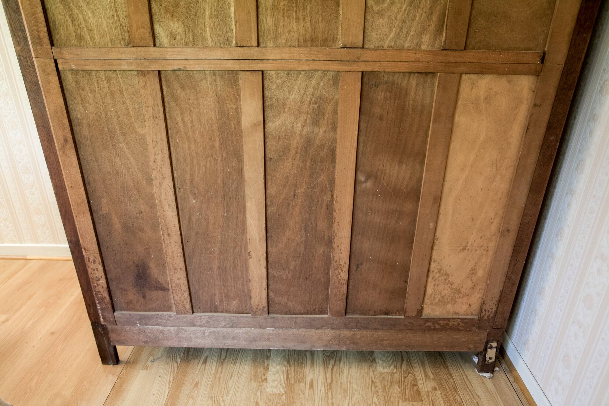 Old solid wood wardrobe with three vintage mirror doors