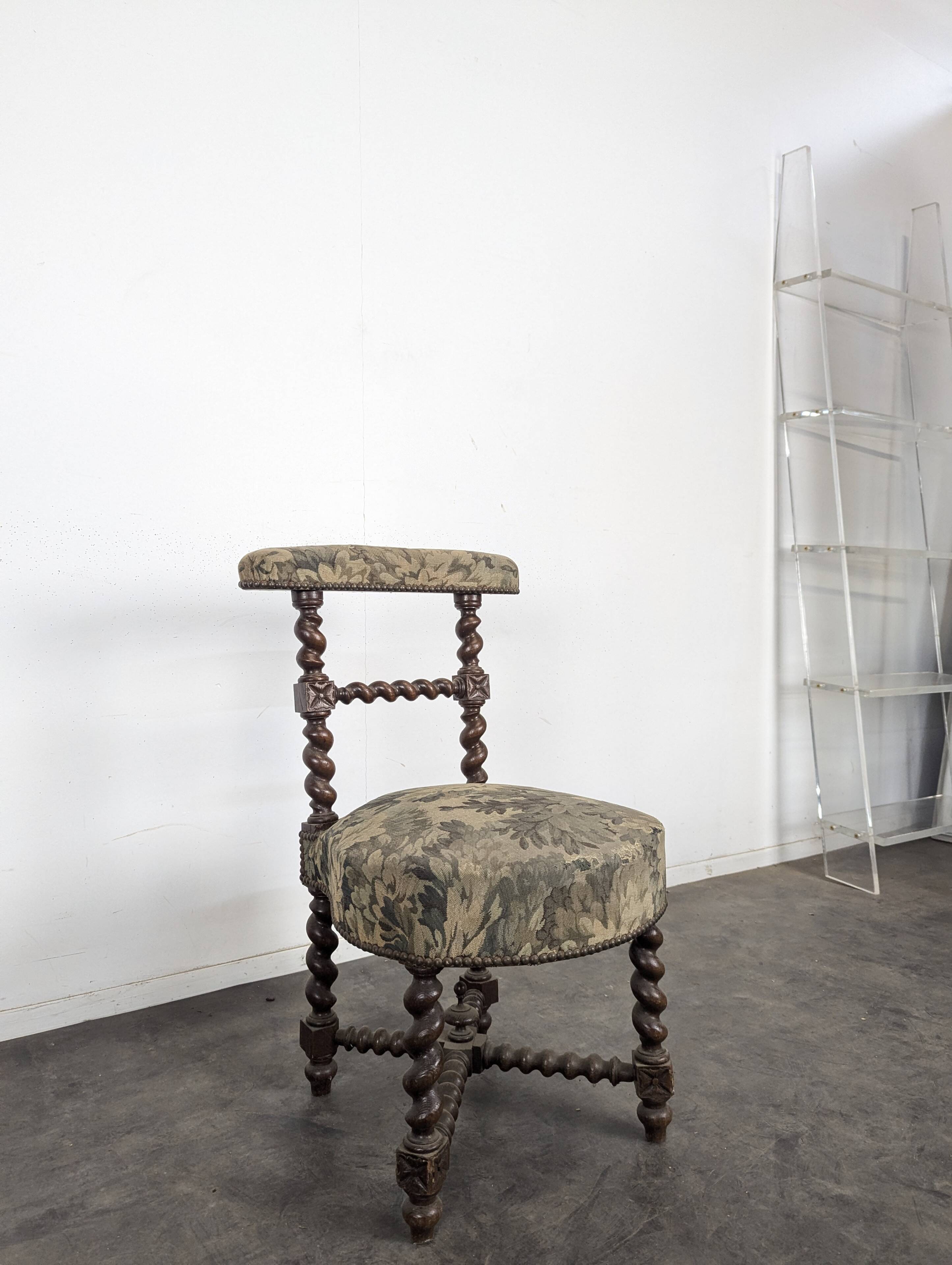 Napoleon III smoking chair in twisted blackened wood with foliage upholstery.