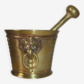 Old mortar and its nineteenth century hapothicarian pestle in bronze