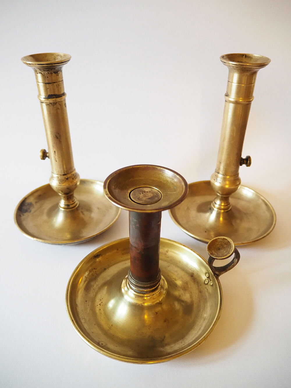 Set of three old brass candle holders