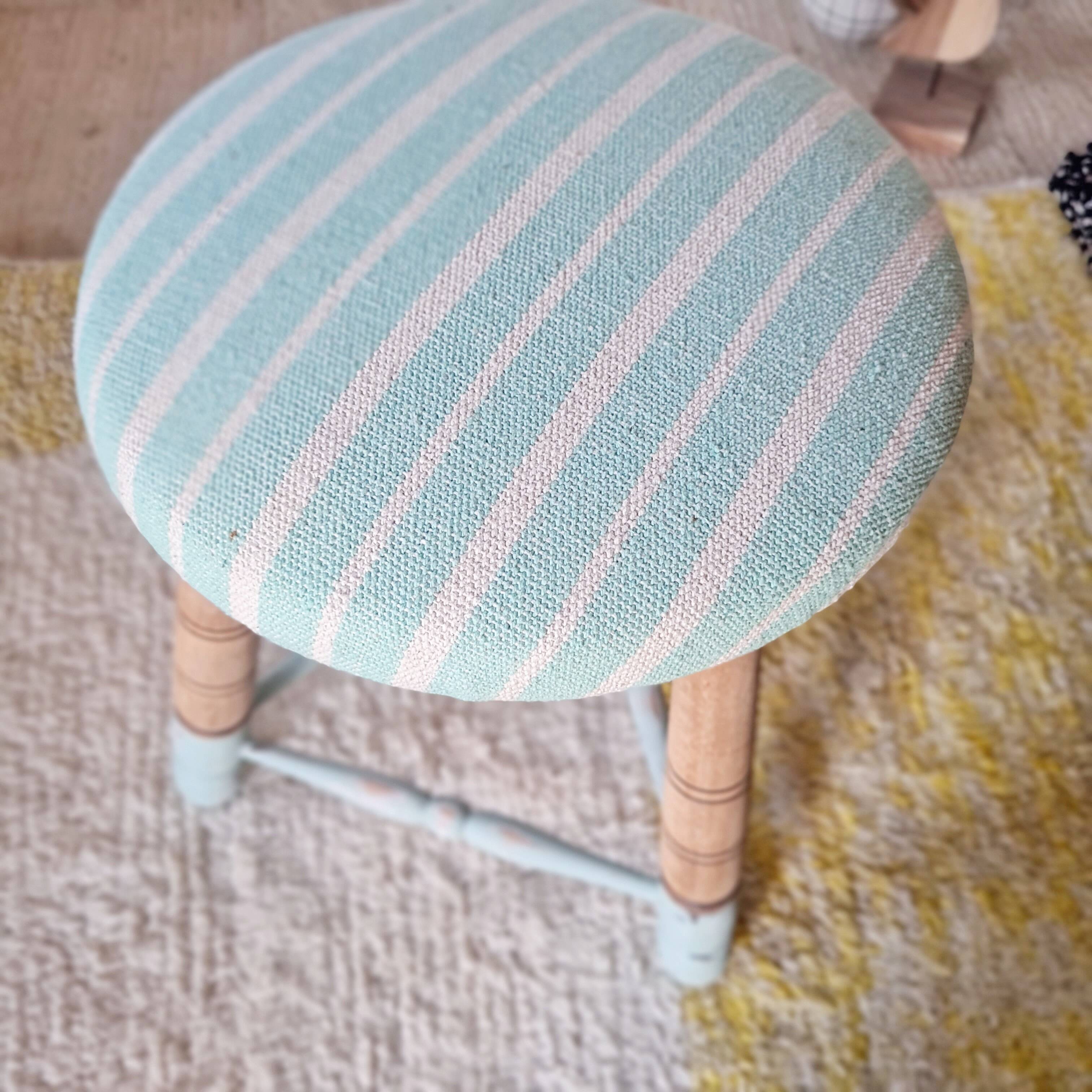 Antique tripod stool with striped seat