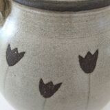 Beige stoneware teapot with stylized flowers and rattan handle