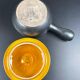 Black and yellow fondue pot