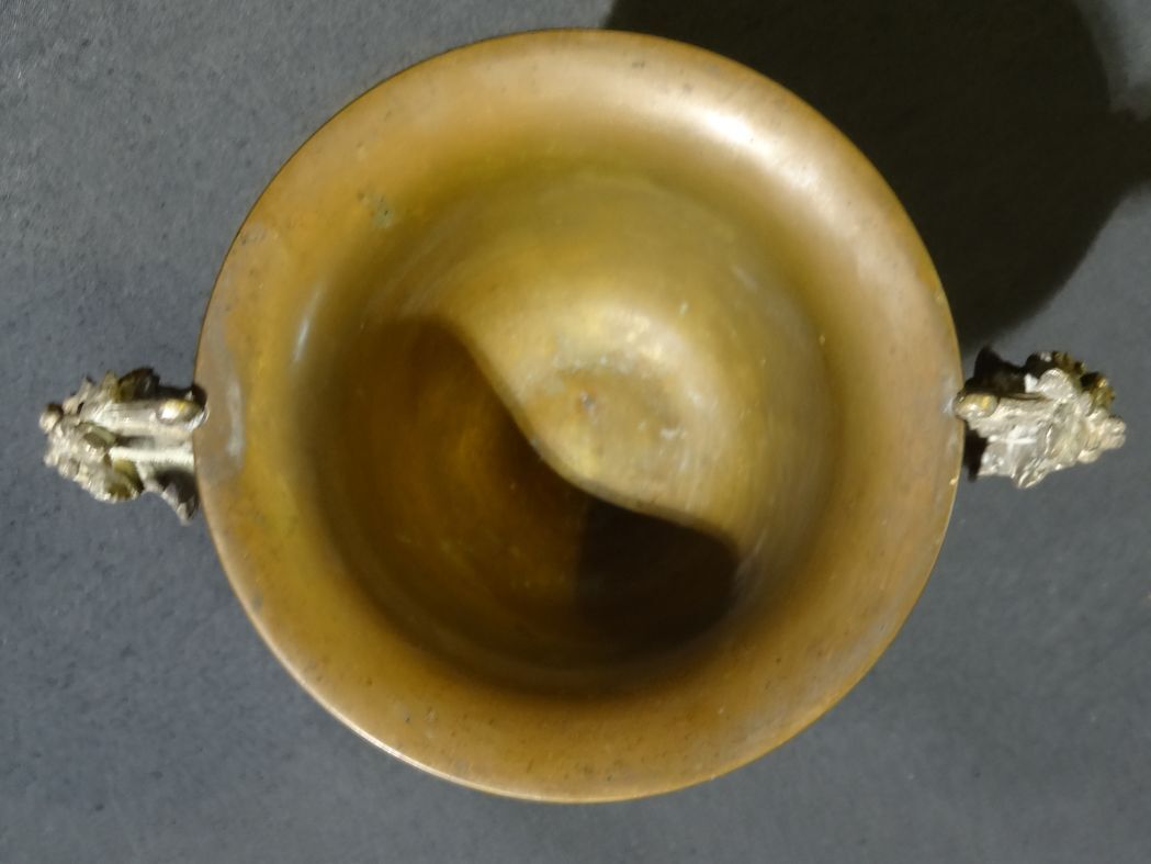 Carved silver bronze vase mounted on marble pedestal