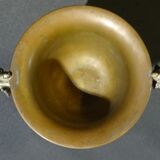 Carved silver bronze vase mounted on marble pedestal