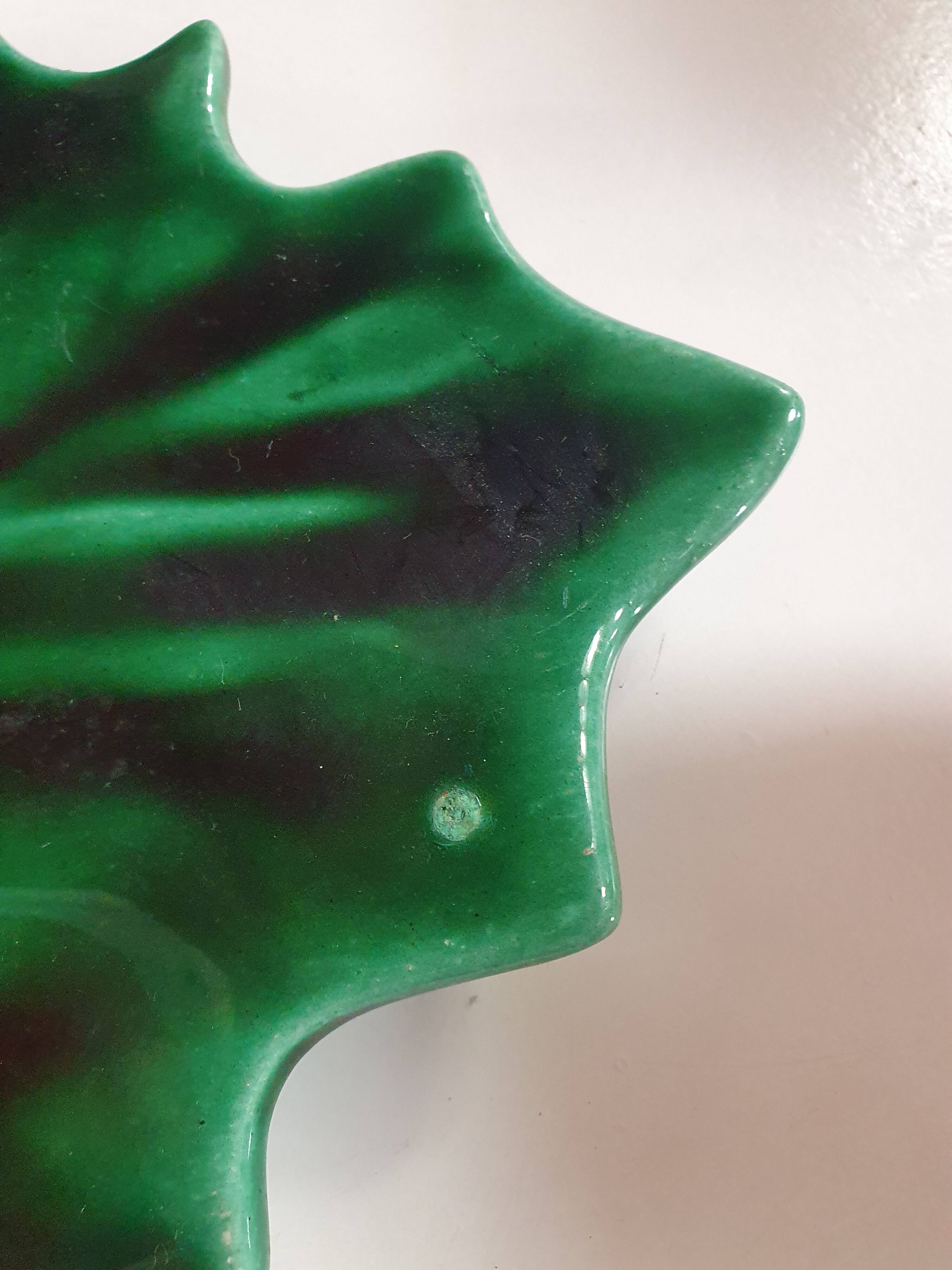 empty green ceramic pocket cup, small chips on the edges, signed