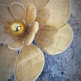 Flower wall light made of rattan and raffia petals