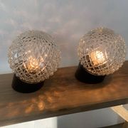 Pair of slanted glass wall lights with black plastic base, decorative v