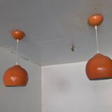Pair of 70's globes in orange lacquered metal.