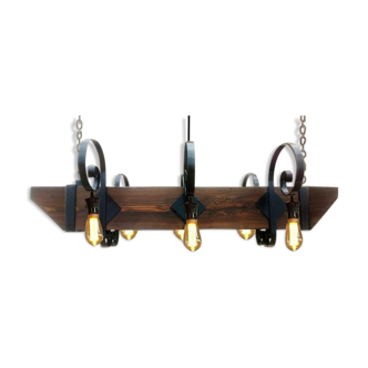 Wrought iron chandelier and wooden beam