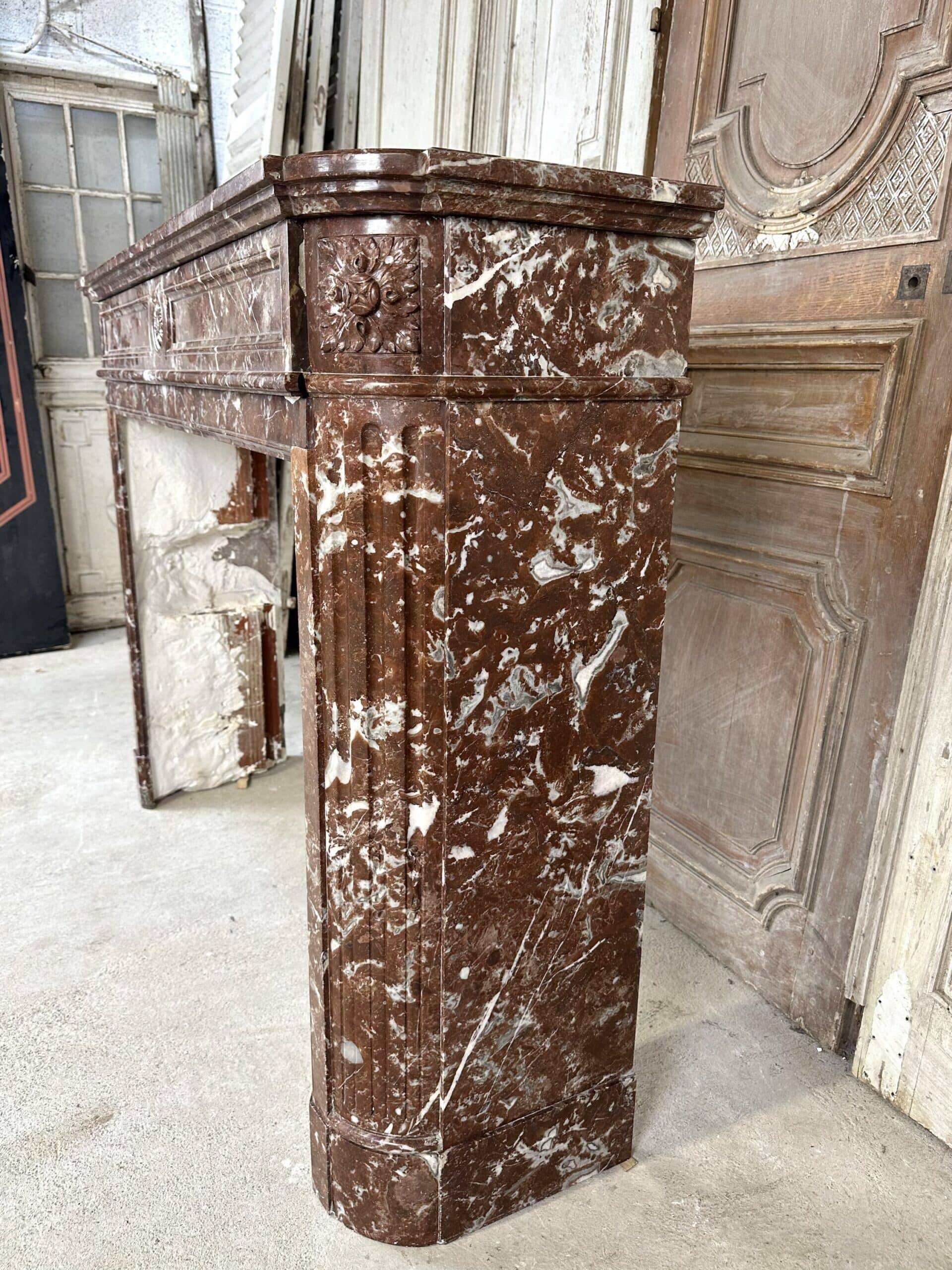 Red marble fireplace in the Louis XVI style, late 19th century