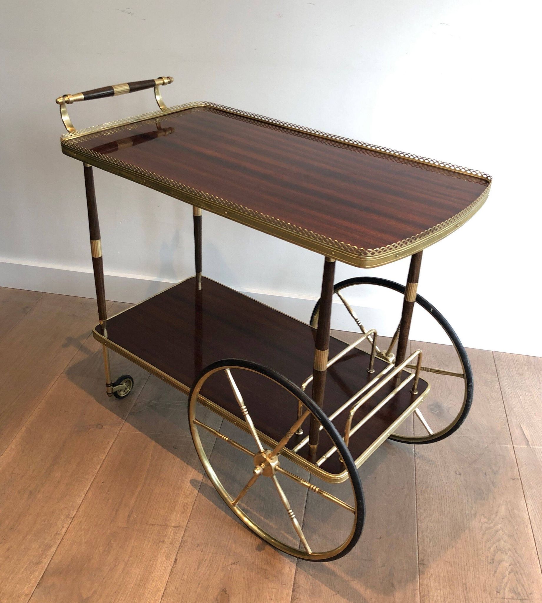 Mahogany and brass rolling table in the style of Maison Jansen.