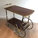 Mahogany and brass rolling table in the style of Maison Jansen.