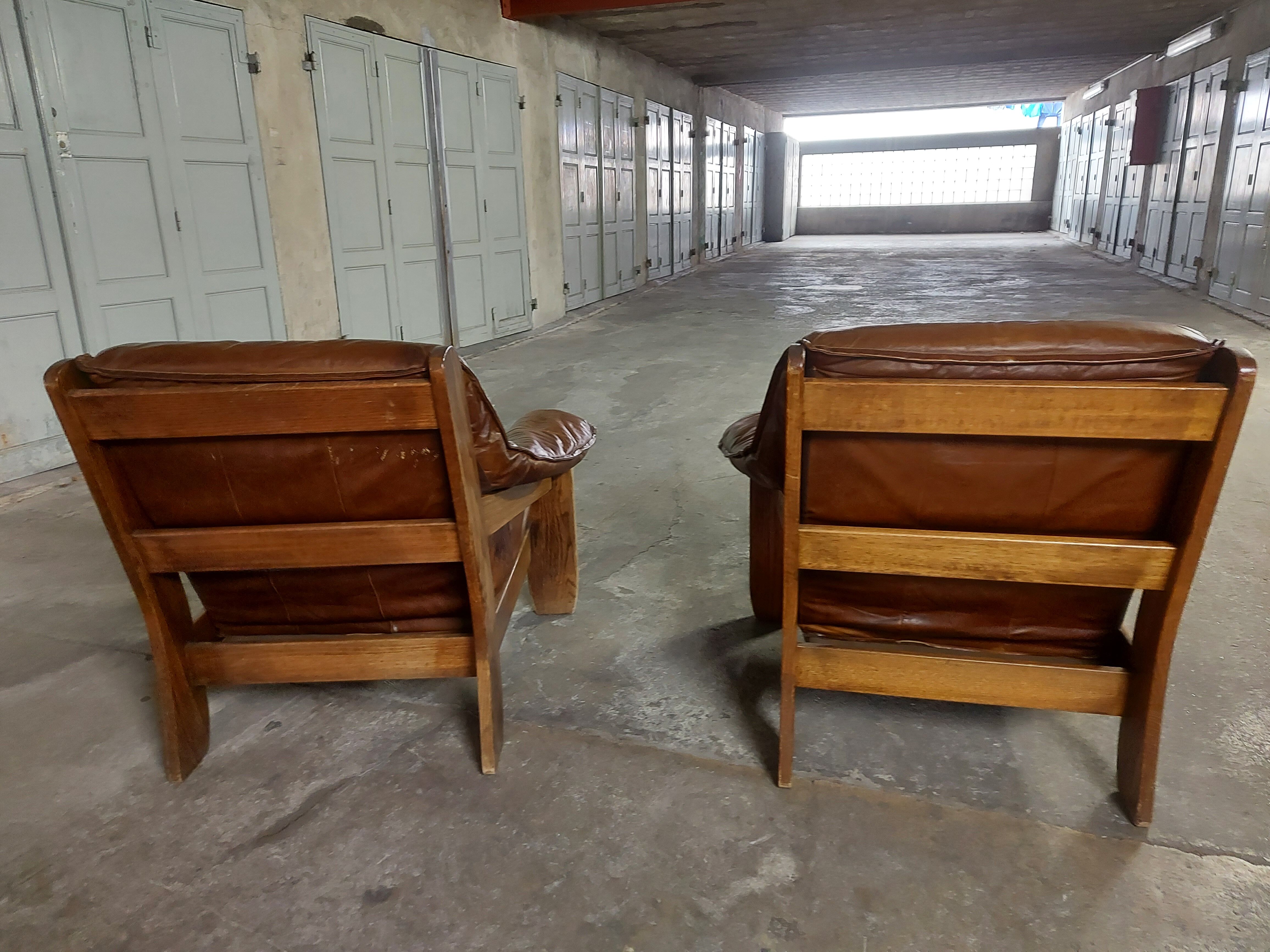 Armchairs in leather and vintage wood 70's