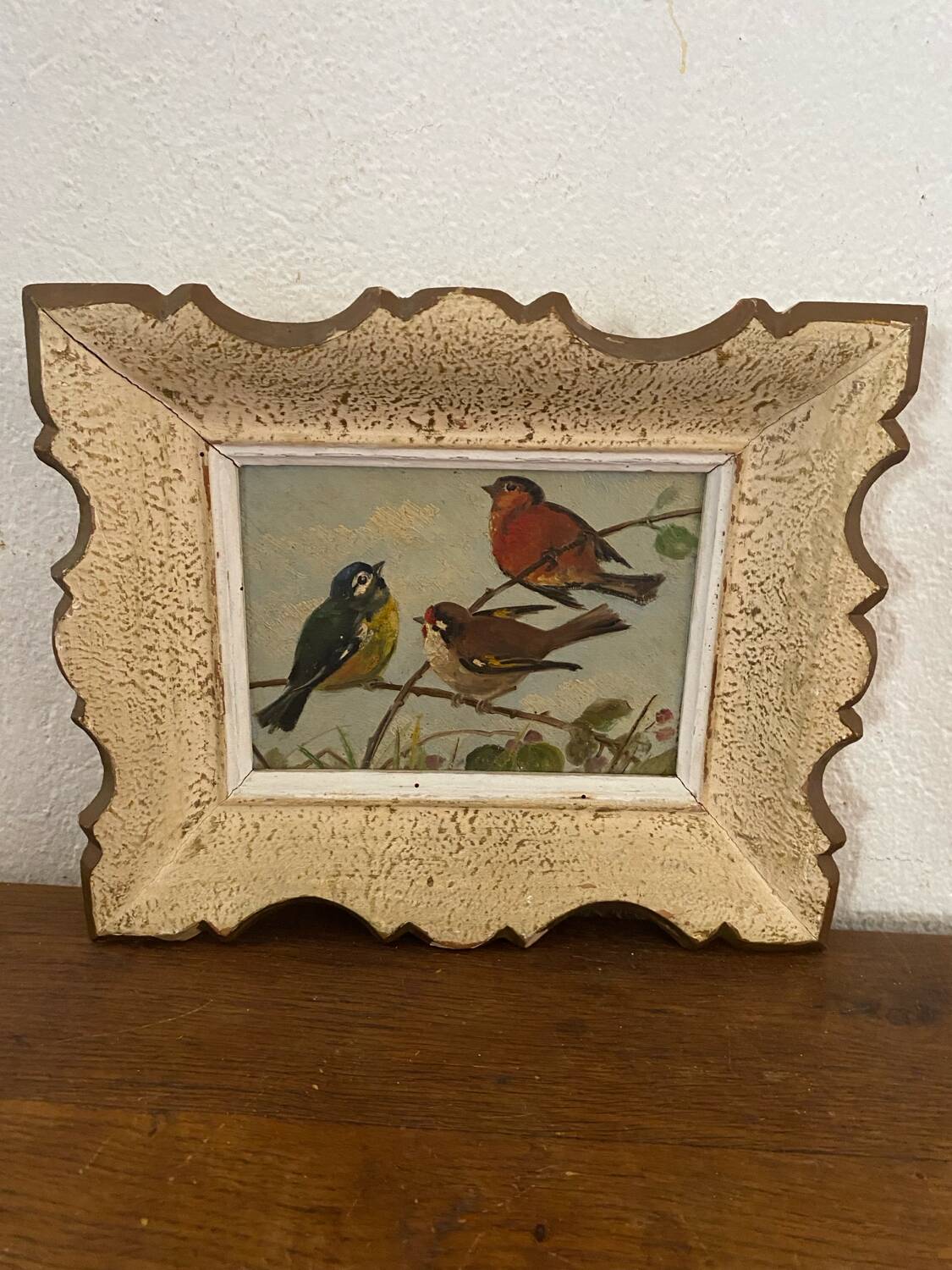 Vintage painting on panel of 3 tits on a branch.