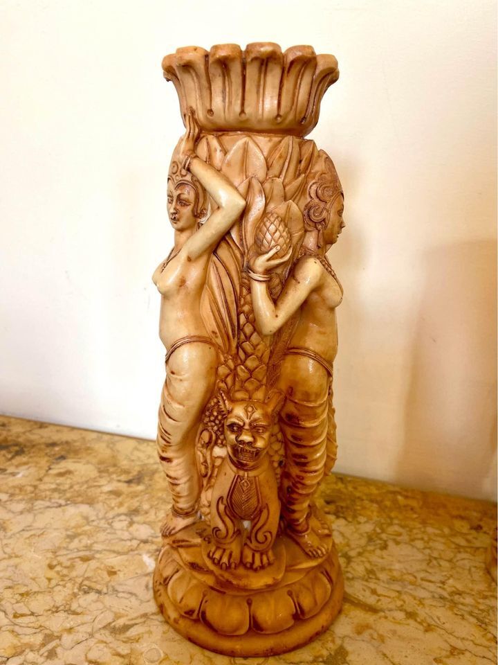 Two ancient Indonesian candlesticks.