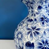 Blue and white ceramic vase with floral pattern in the shape of a vintage ball
