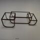 Asymmetrical metal-and-glass coffee table with curved architectural frame.