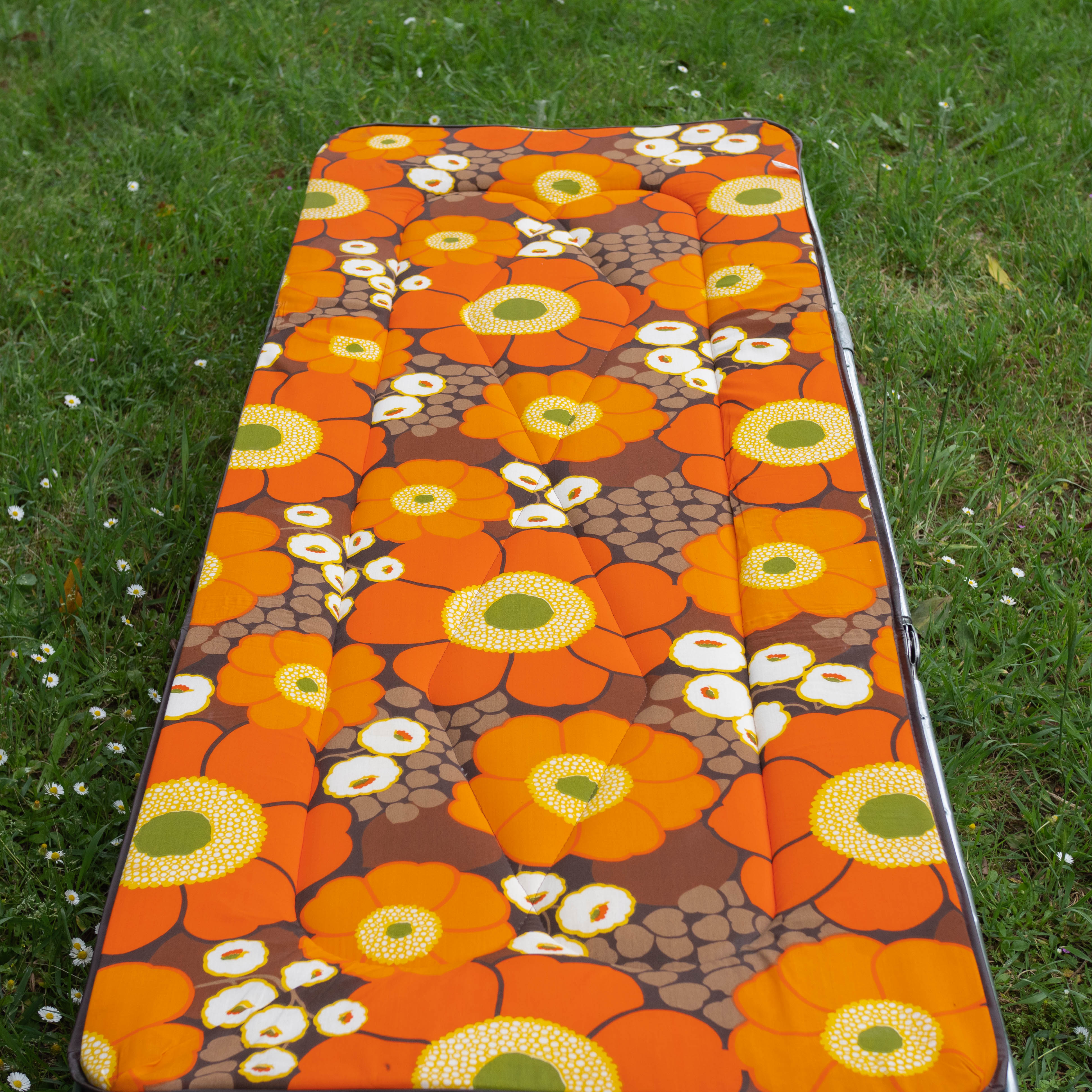 Vintage camp bed with orange flowers