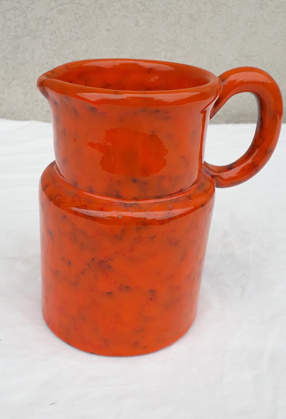 Orange ceramic pitcher
