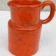 Orange ceramic pitcher