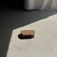 Small stool, teak footrest with short cut corners.
