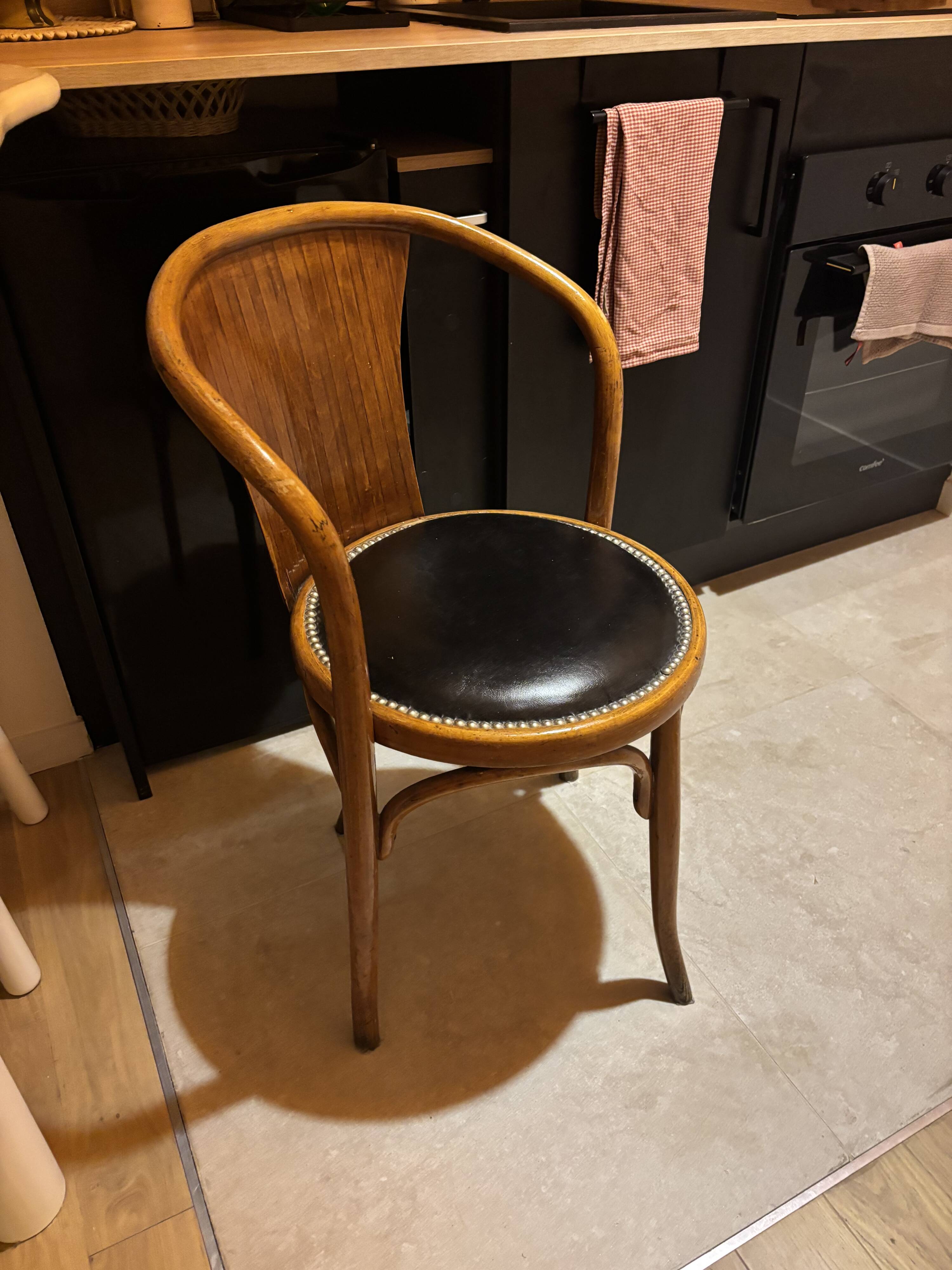 Wooden chair with black leather seat