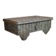 Low chest with metal closure and top opening.