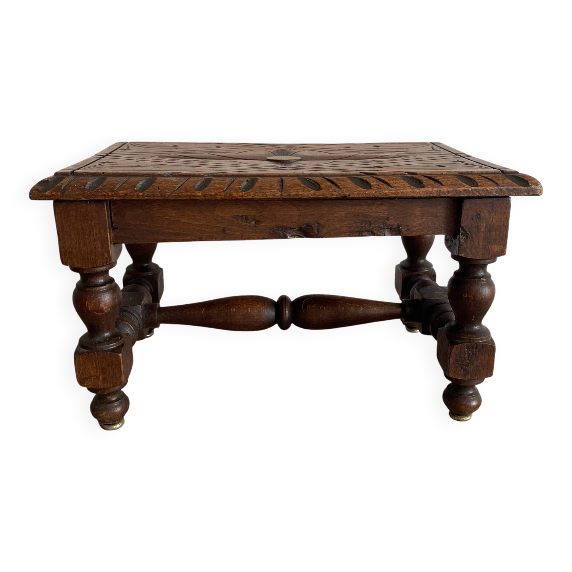 Low stool in carved wood