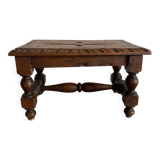 Low stool in carved wood