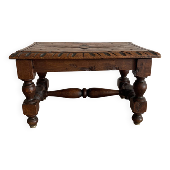 Low stool in carved wood