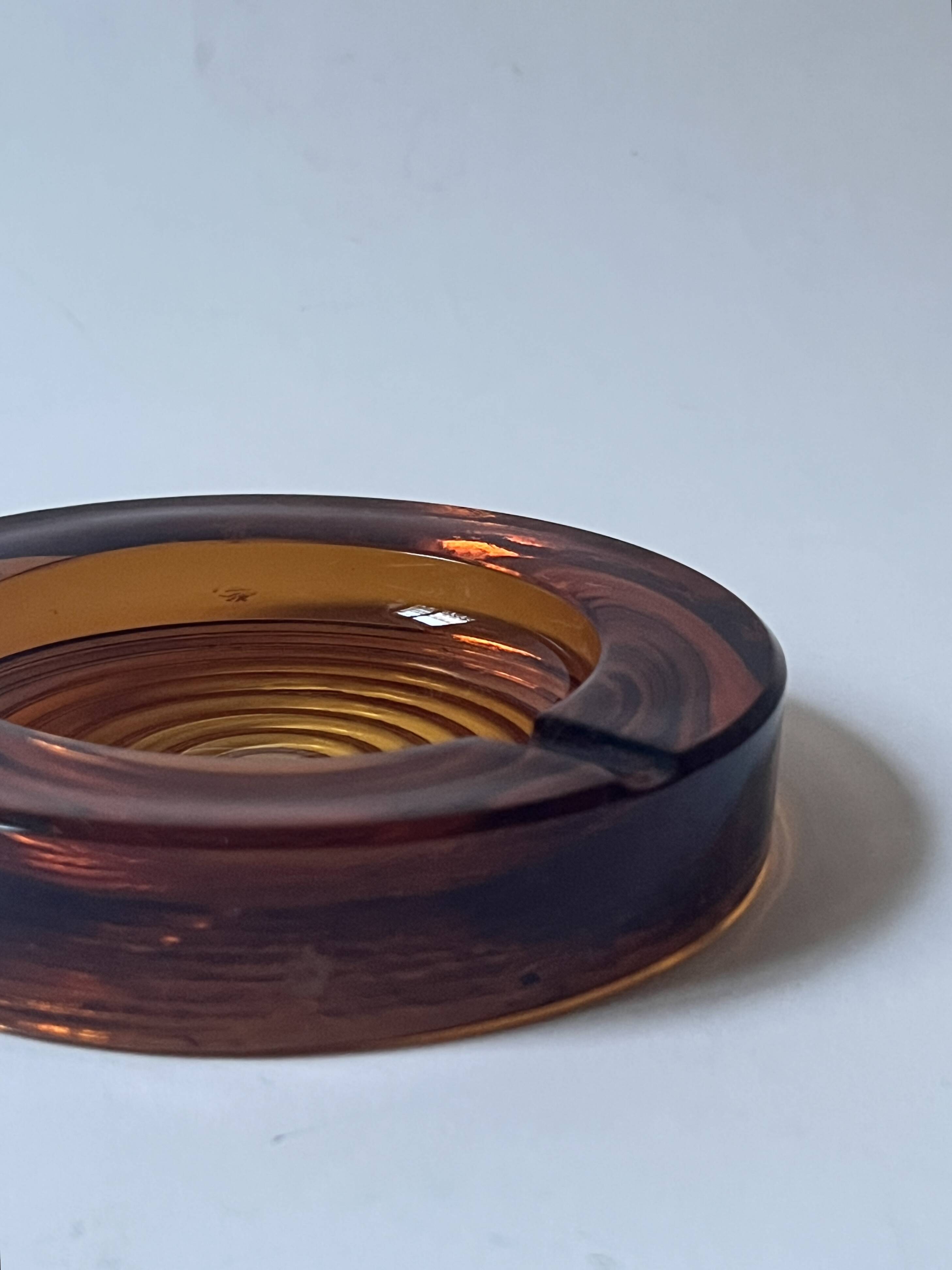 Amber pressed glass ashtray, 1970s design.