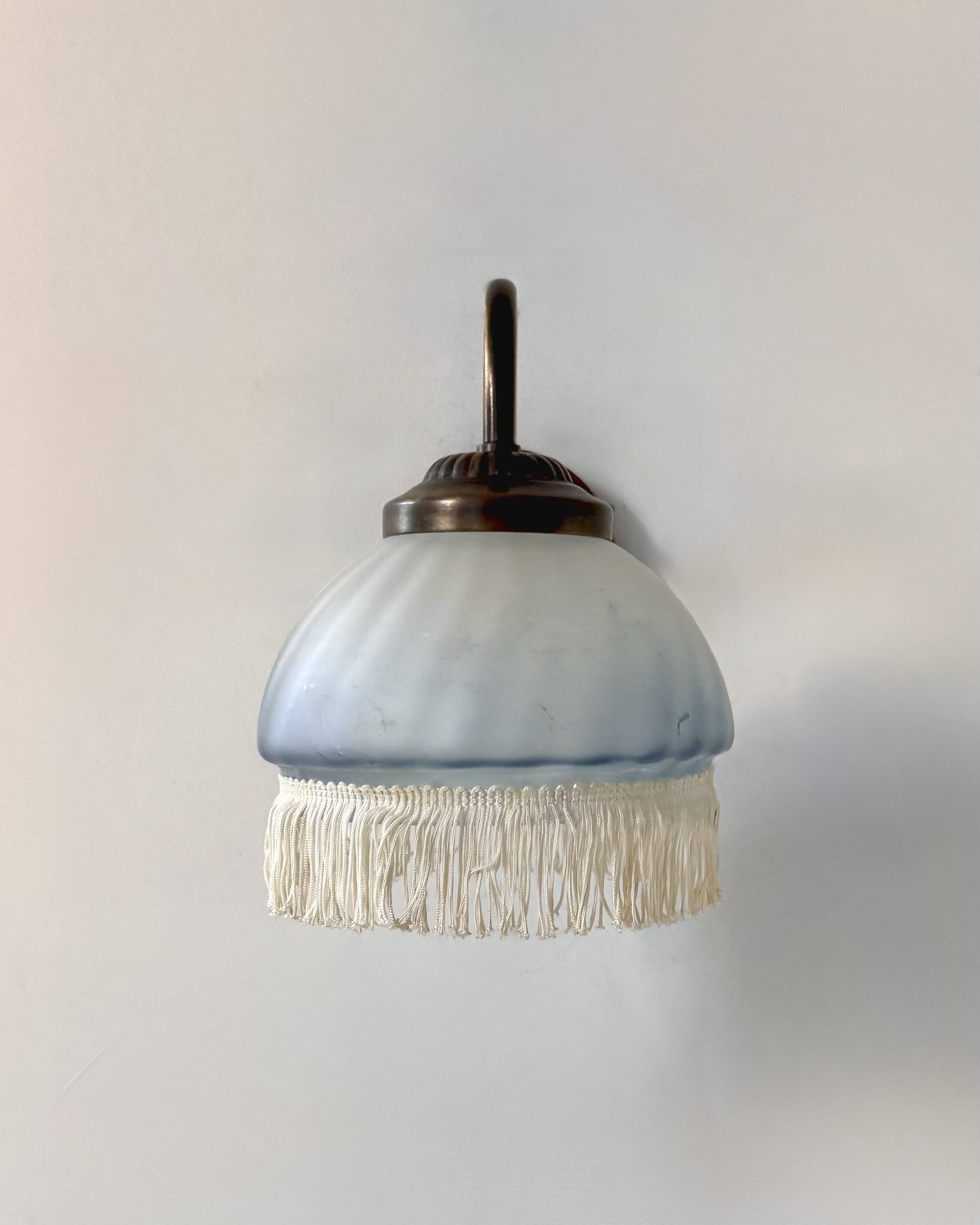 Pair of vintage wall lights in brass and blue-tinted glass, France 1970.