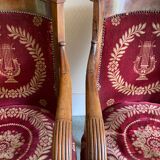 Paire de fauteuils Empire bordeaux à motif lyre , pieds sabre, accotoirs sculptés têtes de dauphin X